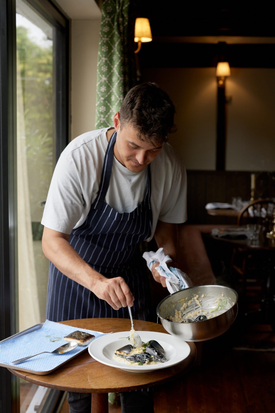 food being plated in restaurant kitchen